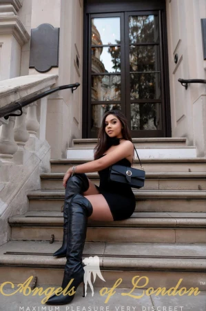 London escort Junsy in black leather boots