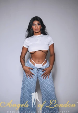 London escort Reba in white top and jeans