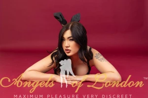 London escort Kumiko on floor with legs crossed