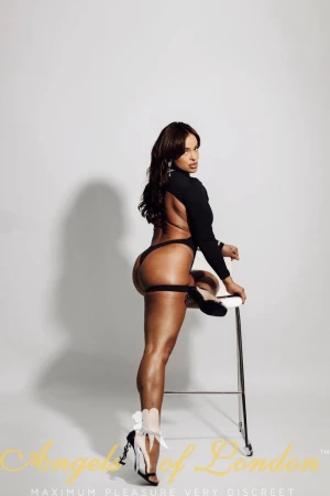 London escort Morela black lingerie on stool