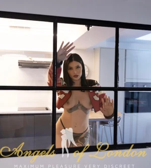 London escort Minola at the window
