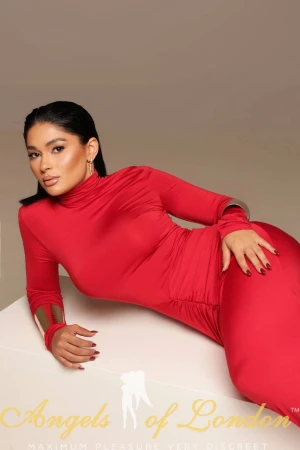 London escort Gella in red dress on the floor
