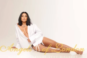 London escort Gella on the floor in white shirt