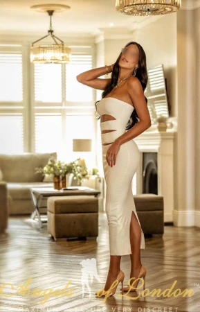 London escort Tarla in white dress