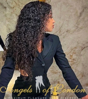 London escort Simonika in black suit