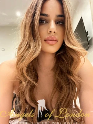 London escort Albertine with long wavy hair
