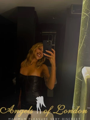 London escort Belissa smiling mirror selfie