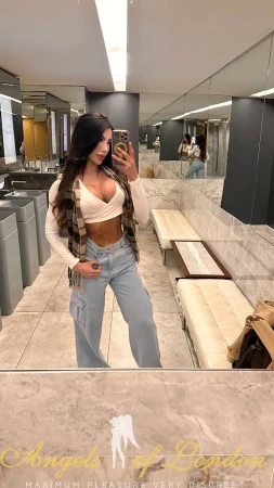 London escort Manori selfie in white top and jeans