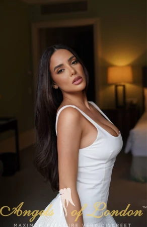 London escort Denella white dress