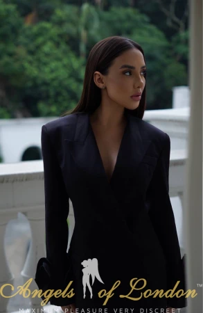 London escort Denella in black jacket