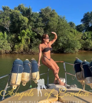 London escort Helma on boat in bikini