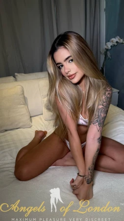 London escort Elvin showing tattoo