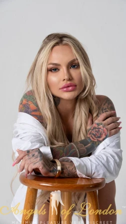 London escort Glo showing face and tattoos