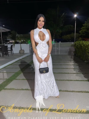 Busty escort Nerisha in white dress