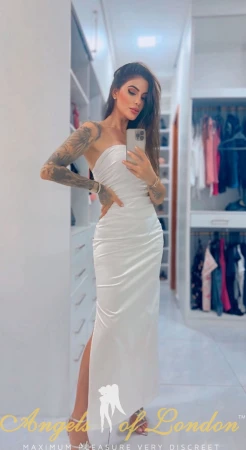 Brazilian escort Freesia mirror selfie in white dress