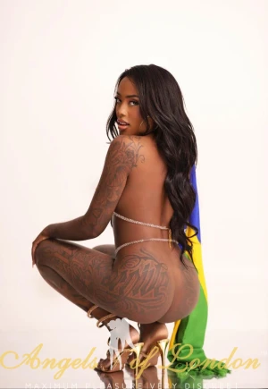 Black escort Bonamy showing tattoos from the back