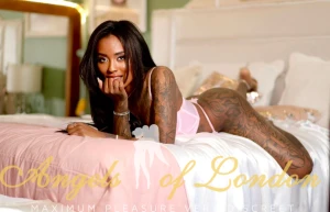 Black escort Bonamy on the bed