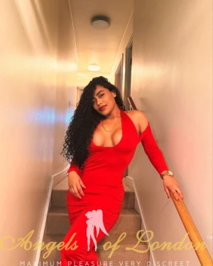 Colombian escort Ventella on stairs in red