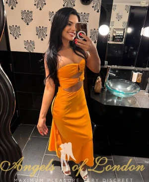 London escort Ainava in yellow dress
