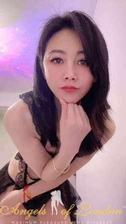 London escort Lina in lingerie looking into cam